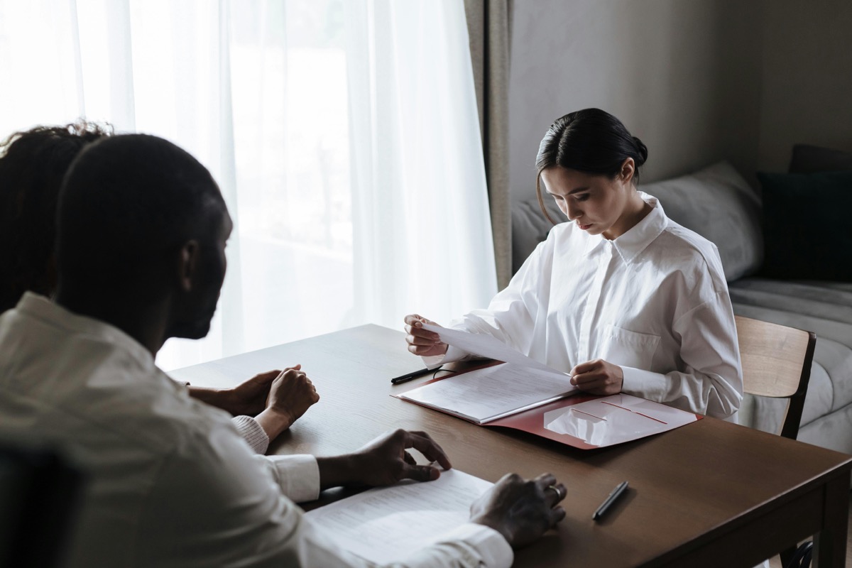 Immigration consultation with documents on a desk