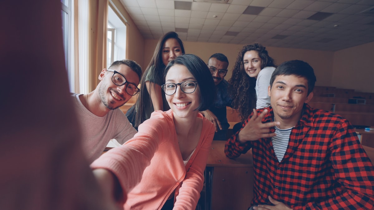 Students smiling together in a classroom